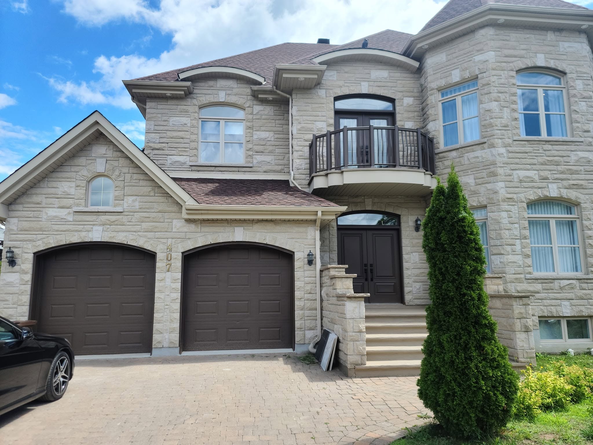 Finished home exterior with dark garage doors and trim